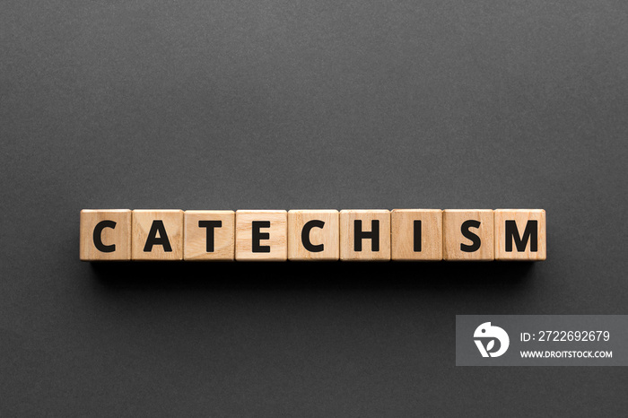 Catechism - words from wooden blocks with letters, principles of Christian religion catechism concept, top view gray background