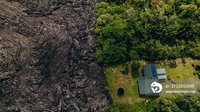 Frozen lava from Kilauea Volcano in Hawaii near house