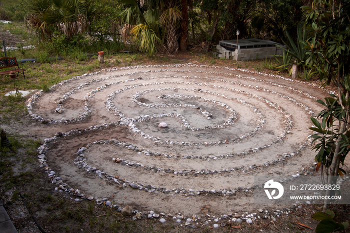 An old traditional stone and seashell labyrinth in public park in tropical florida