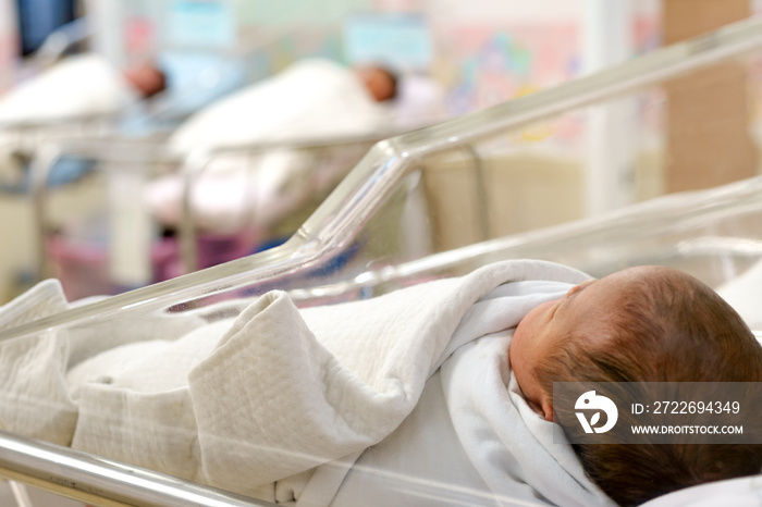 newborn babies in nursery area of hospital