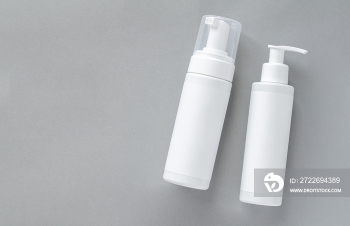 Mock-up of white plastic cosmetics bottles with skincare