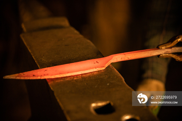 Forging a knife out of the hot metal