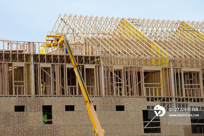 Installation of wooden beams at construction of the frame house material