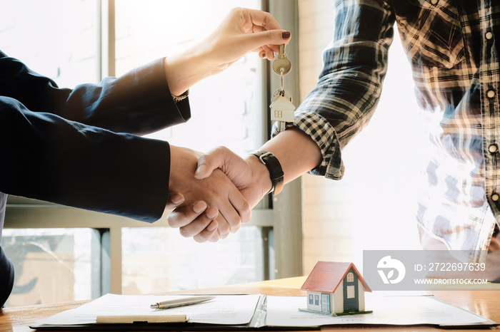 Real estate agent and customers shaking hands together celebrating finished contract after about home insurance and investment loan, handshake and successful deal