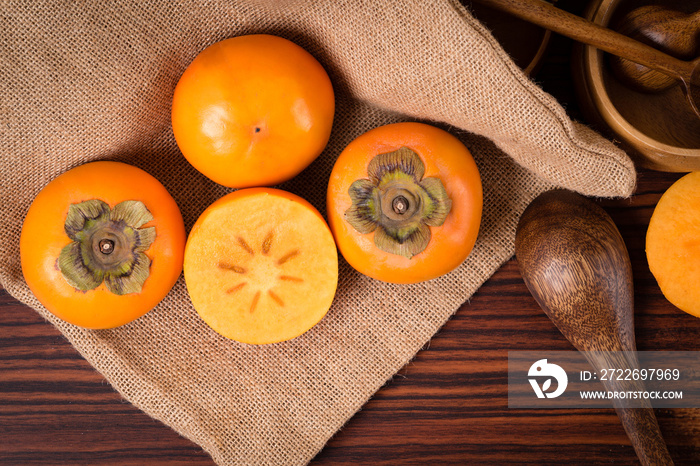 Top view of Persimmon fruit on rustic sack