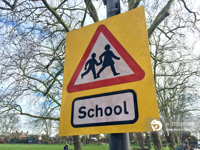 back to school or coronavirus closed concept - school sign UK warning to slow down road sign