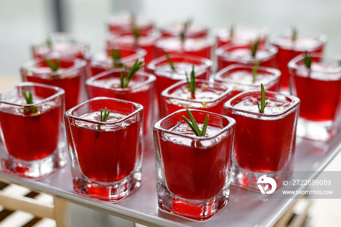 A row of red alcohol shots.