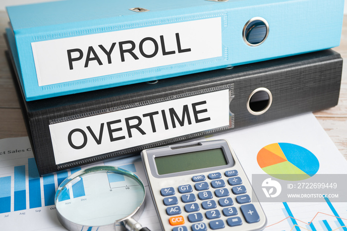 Payroll, Overtime. Binder data finance report business with graph analysis in office.