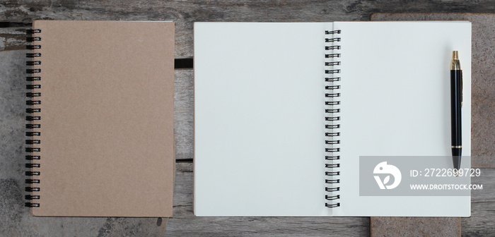 Design concept - Top view of hardcover kraft notebook and ballpoint pen