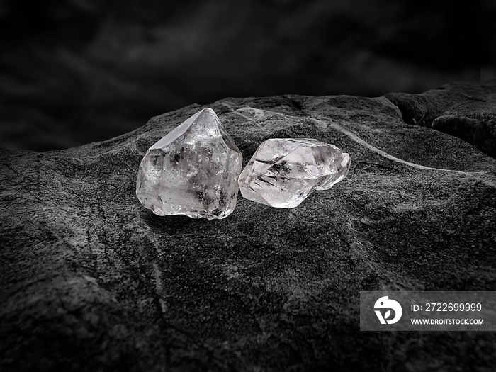 Natural diamond nestled on black coal background