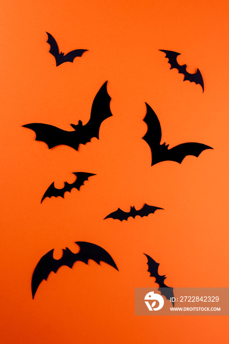 Black paper bats on vertical orange background