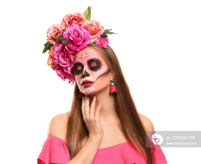 Young woman with painted skull on her face for Mexicos Day of the Dead against white background