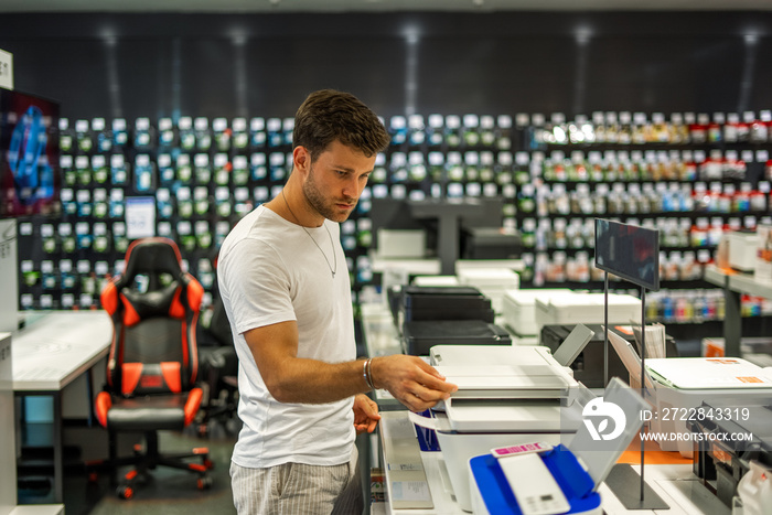 Man choosing printer in store