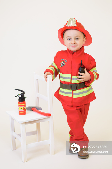 Little toddler child, playing with fire truck car toy and little chicks at home, kid and pet friends