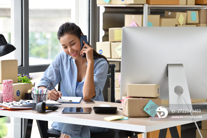 Young Asian woman entrepreneur/ Business owner working with computer at home