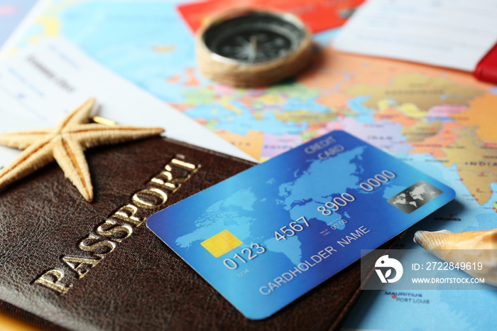 Credit cards with passports and tickets for vacations on the world map background