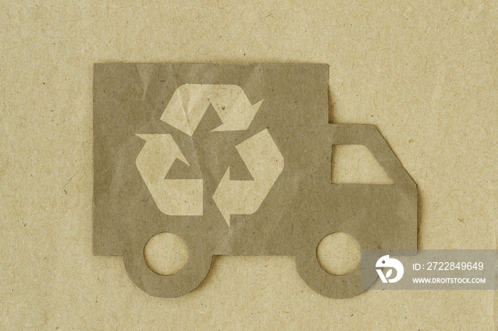 Paper cut of truck with recycling symbol on recycled paper background - Green transportation concept