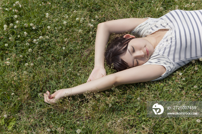 Young woman lying on grass