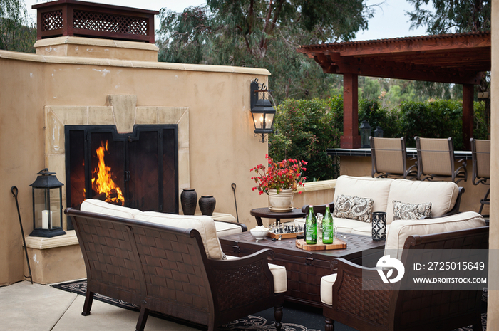 Outdoor furniture by fireplace at patio; Rancho Sante Fe; USA