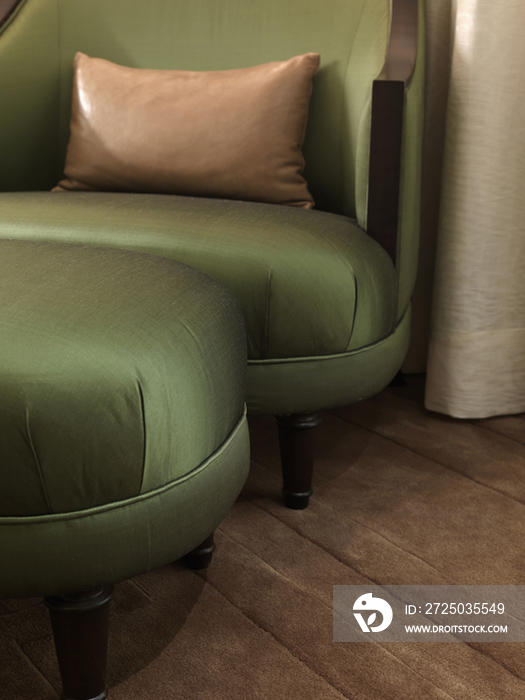 Close-up green easy chair and footstool