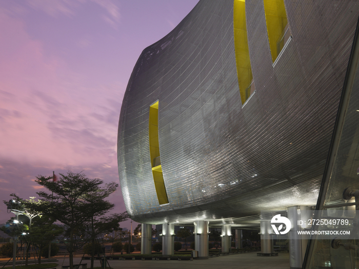 Exterior of modern shopping mall at dusk