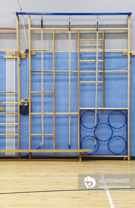 Gymnasium equipment folded away at the side of the sports hall of a modern secondary school