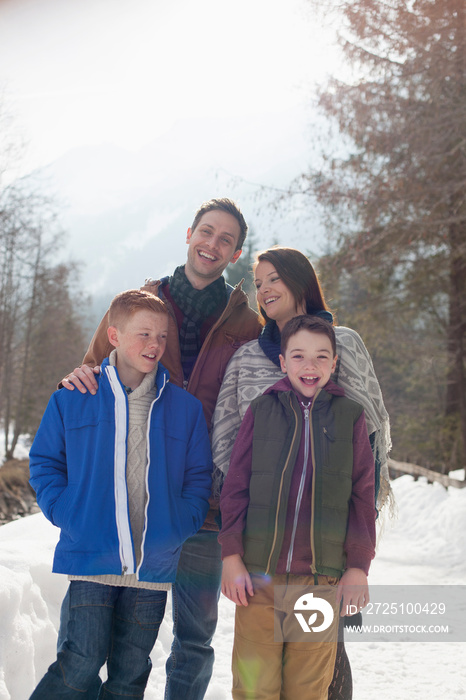 Happy family on snowy footpath