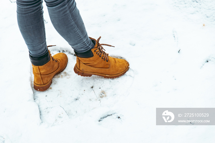 woman winter boots on snow close up