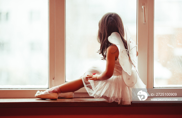 Dreamy girl at the window