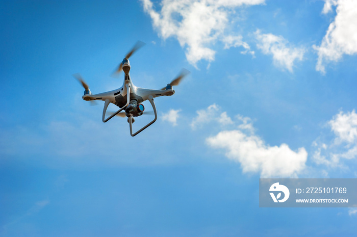 Drone inspect farmland, fly at sky with clouds. Concept of technology in the farm.