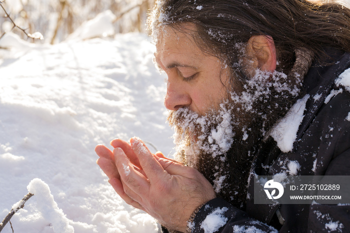 A man with a beard in the snow.