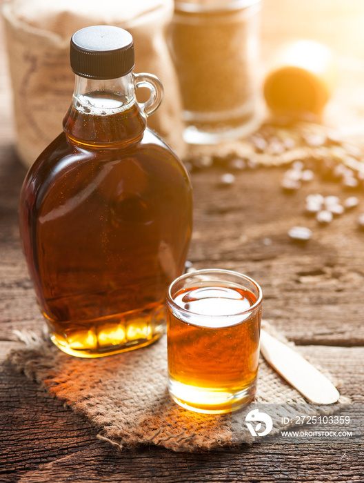 maple syrup in glass bottle on wooden table