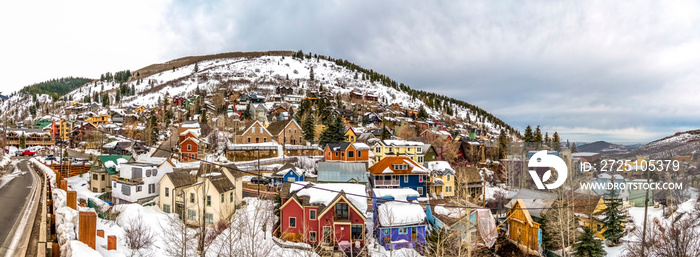 Colorful mountain homes in Park City Utah with cloudy sky background in winter