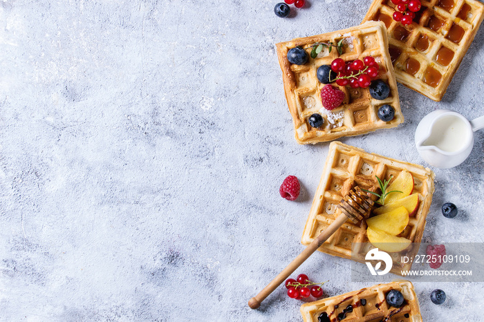 Homemade square belgian waffles with fresh ripe berries blueberry, raspberry, red currant, peach ser