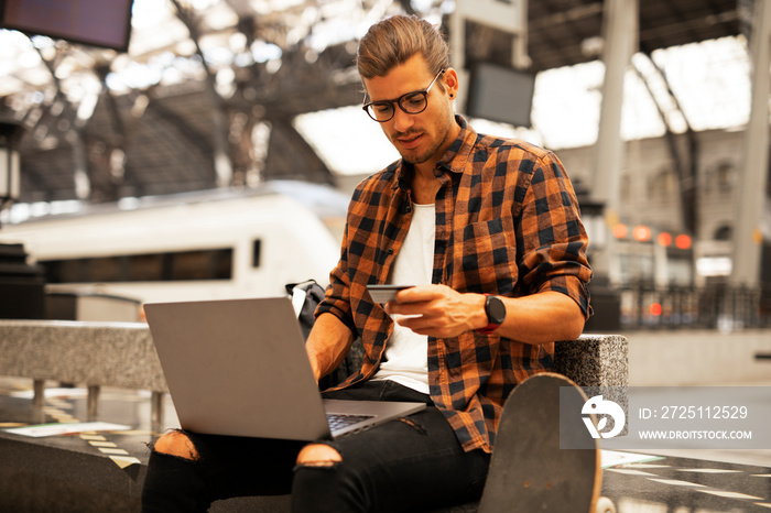 Man shopping online with laptop. Young man buying online with credit card