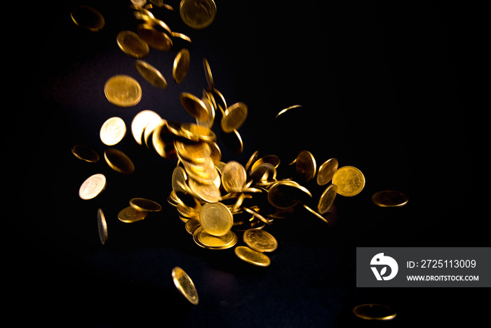 Falling gold coins money in dark background, business concept.