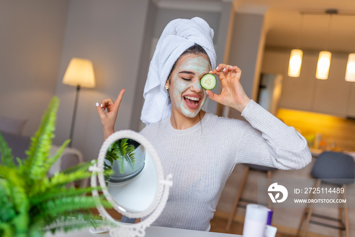 Natural homemade facial masks at home. Woman applying mask on her face and looking in the mirror. Be