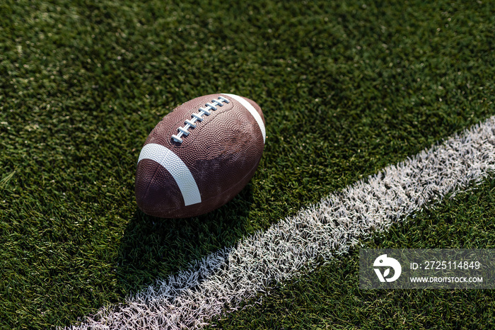 American rugby ball on the grass in the stadium