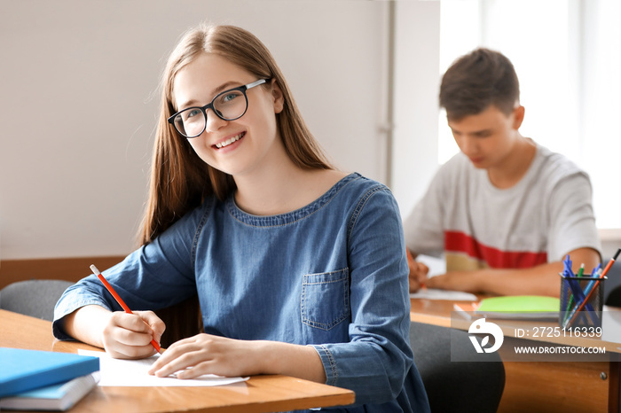 Teenage girl passing school test in classroom