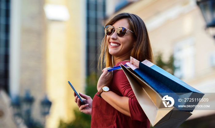 Happy woman in shopping. Consumerism, fashion, lifestyle concept