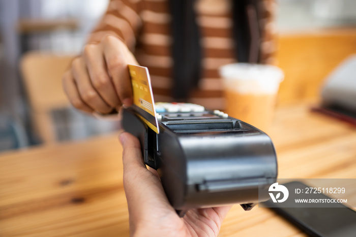 Young asian woman paying her order.