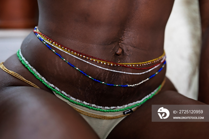 Black woman wearing waistbeads