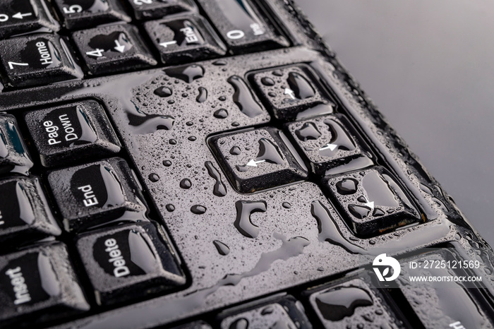 Water drops on the computer keyboard. Water flooded computer keys.