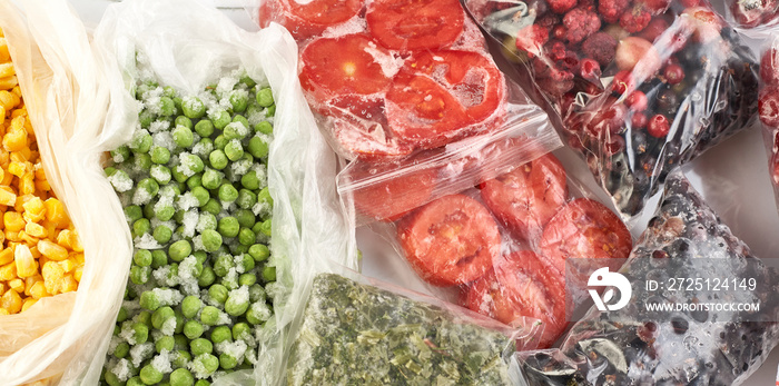 A set of frozen foods for the winter. Frozen berries, vegetables, corn, green peas, tomatoes in the 