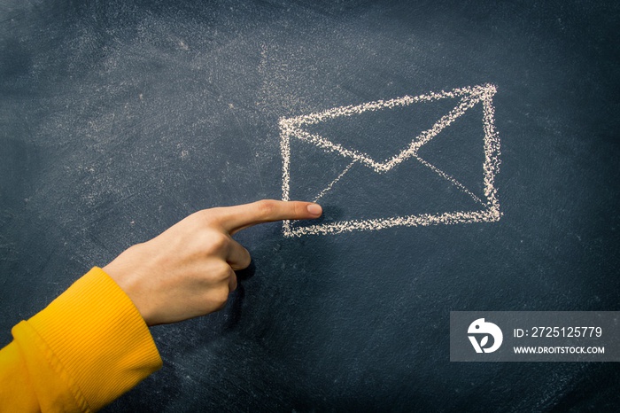 hand with mail envelope drawn on the blackboard