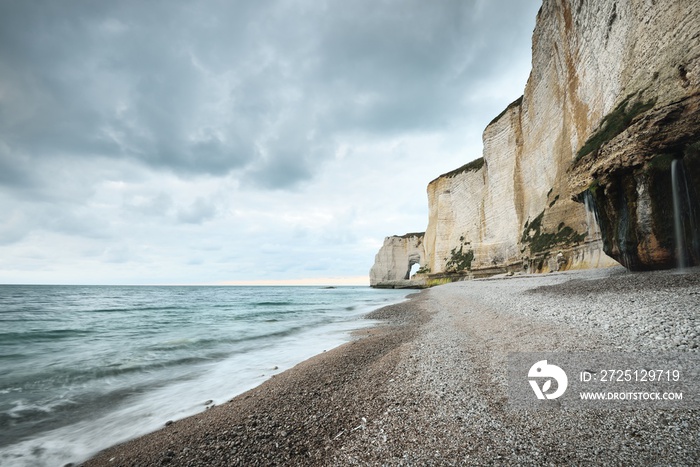 Picturesque panoramic low angle view of the Etretat white cliffs. Dramatic sky, atmospheric landscap