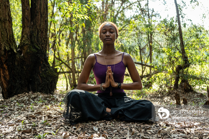 woman doing the lotus pose in nature