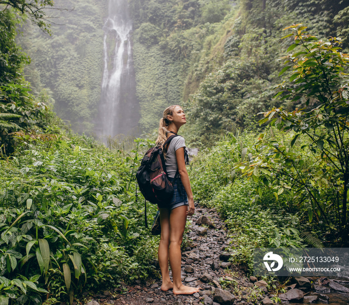 Beautiful woman hiker on forest trail