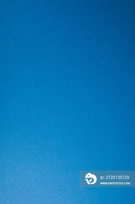 Blue paper background, copy space, vertical.