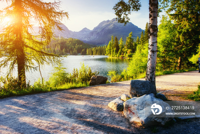 The sunrise over a lake in the park High Tatras. Shtrbske Pleso,